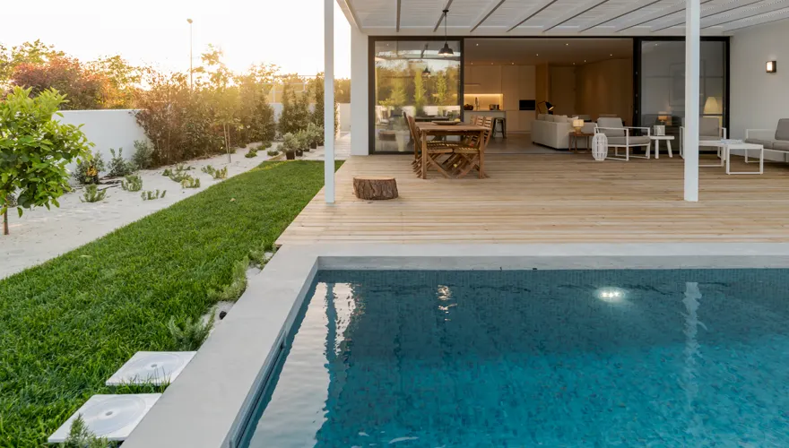 Backyard pool and deck at golden hour
